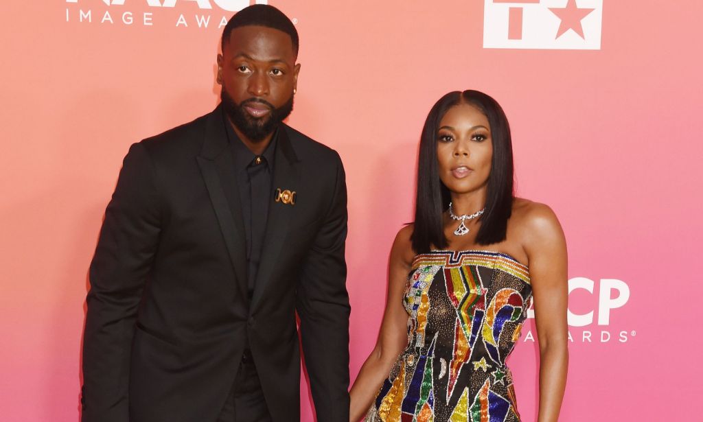 Dwyane Wade and Gabrielle Union stand side by side as they attend the NAACP Image Awards