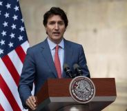 Justin Trudeau in front of a US flag