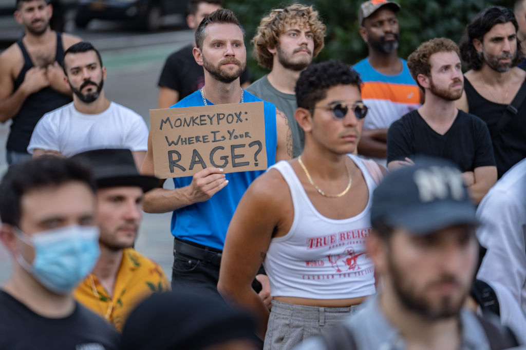 People protest during a rally calling for more government action to combat the spread of monkeypox. 