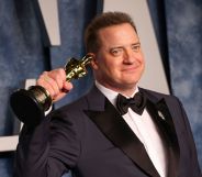 Brendan Fraser holds up his Best Actor Oscar.