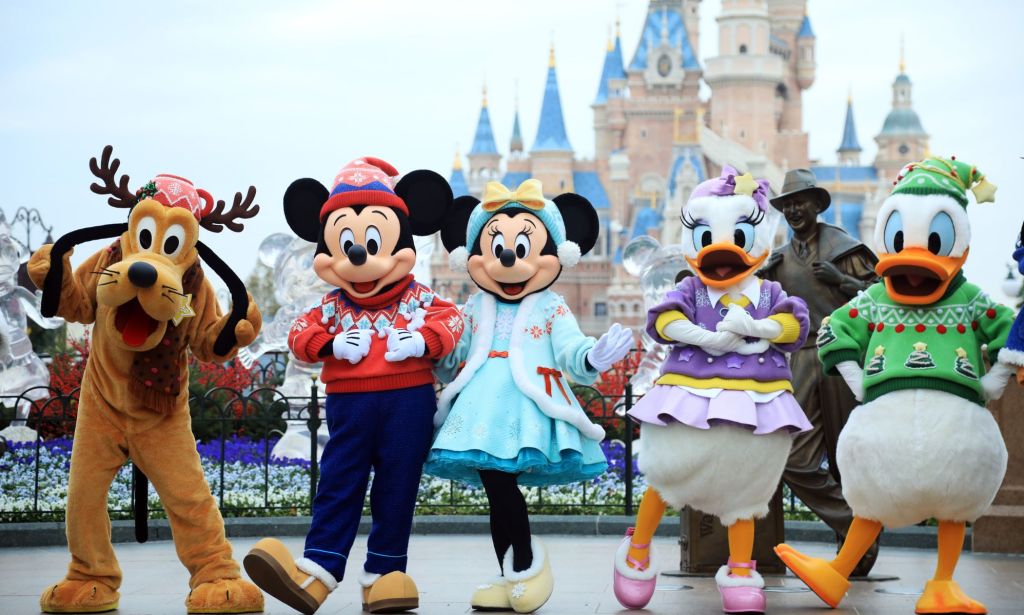 Disney characters in front of the magic kingdom.