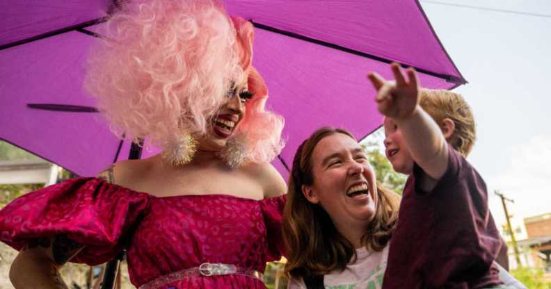 A drag queen with a mother and child