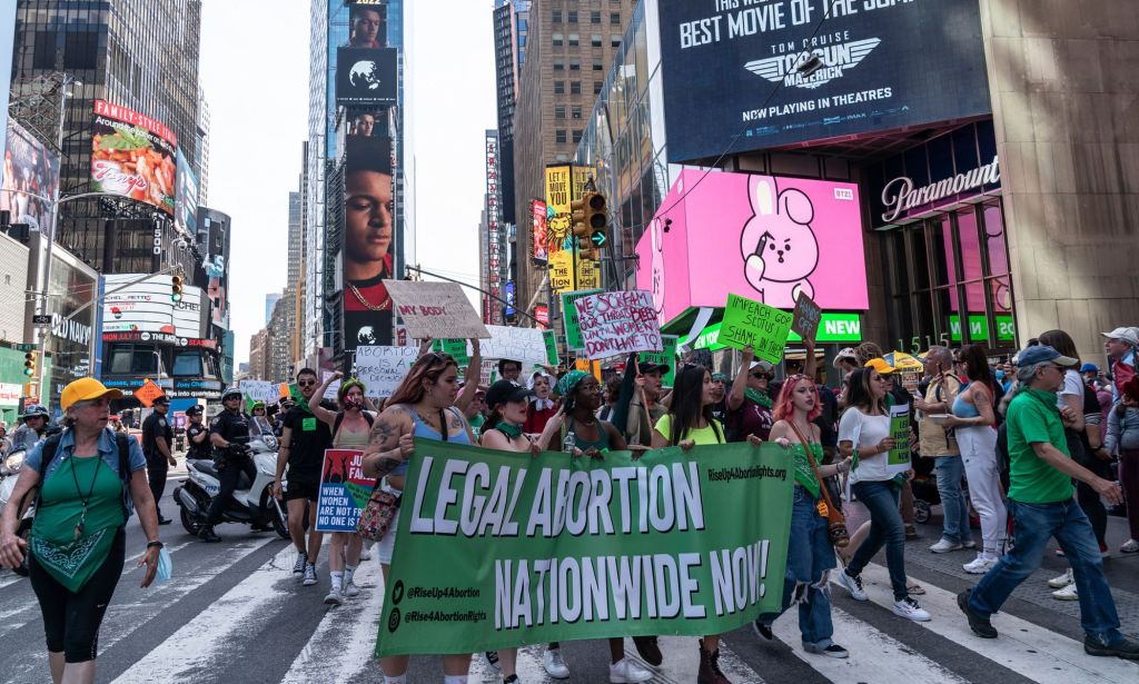 A group of feminist protestors march against the decision to overturn Roe v Wade.