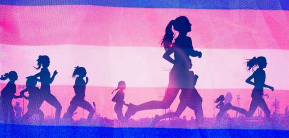 People running in front of a trans flag.