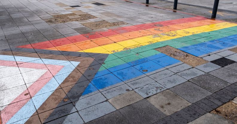 A pavement with an LGBT Pride flag on the tiles.