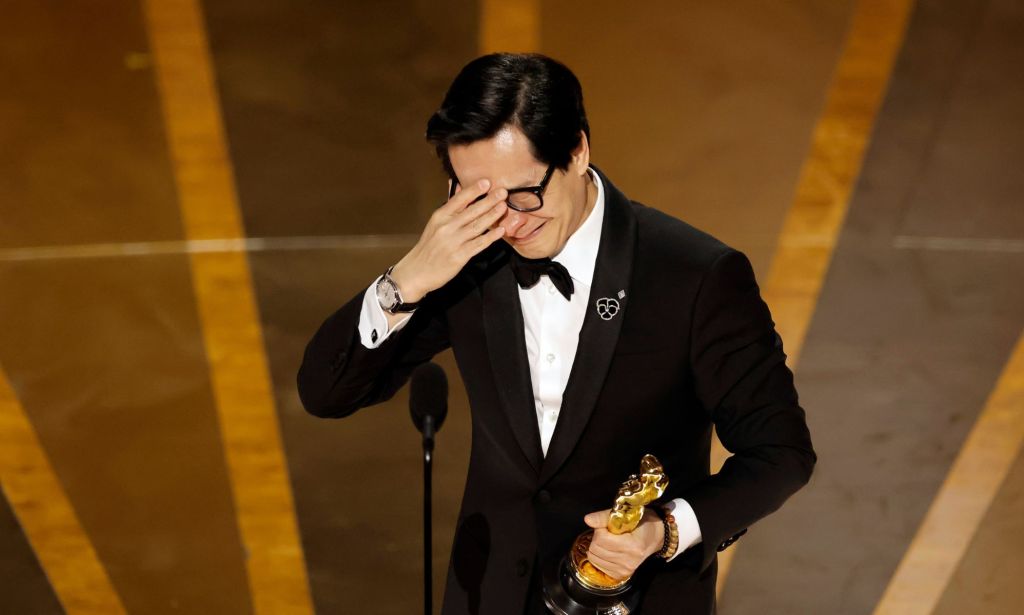 Ke Huy Quan cries into his hand as he accepts the Best Supporting Actor Oscar.