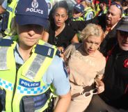 Posie Parker being escorted from her rally.