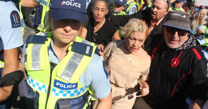 Posie Parker being escorted from her rally.