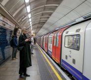 Members of the public wait for a London Underground train.