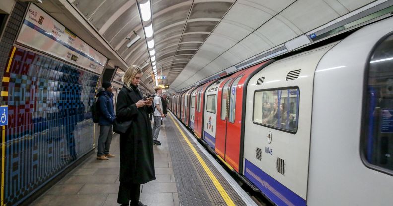 Members of the public wait for a London Underground train.