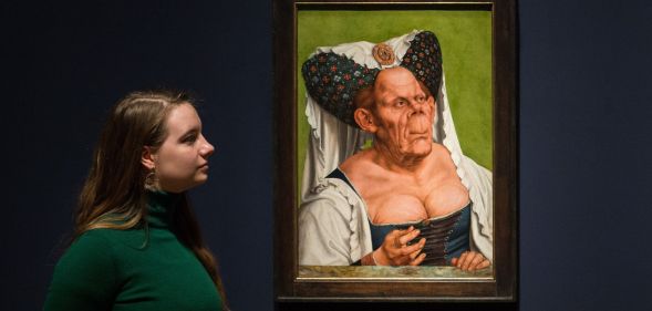 A staff member examine the Ugly Duchess portait.