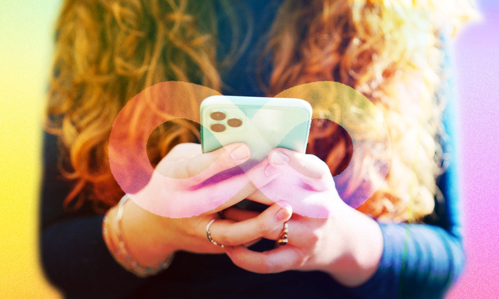 A person with long red hair is using a mobile device.