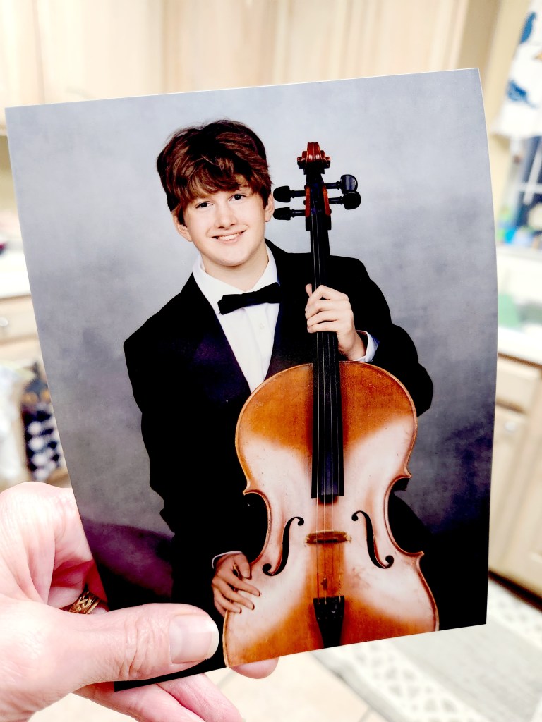 Amber's son holding a guitar