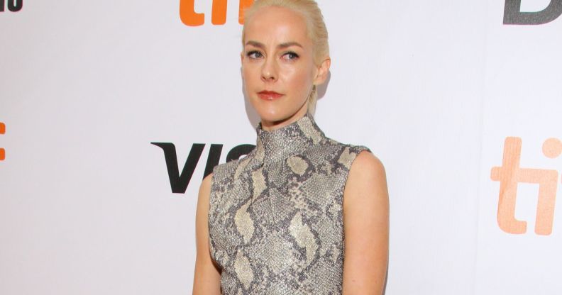 Actor Jena Malone wears a black, white and grey snake skin patterned outfit as she poses for the camera