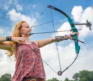 A young girl holding a bow and arrow