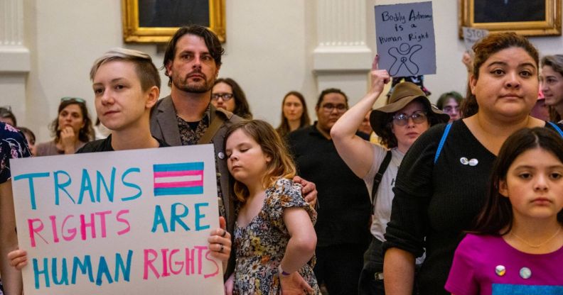 A person holds up a sign reading "trans rights are human rights" during a protest as lawmakers across the US including Texas and Tennessee file bills attacking LGBTQ+ rights