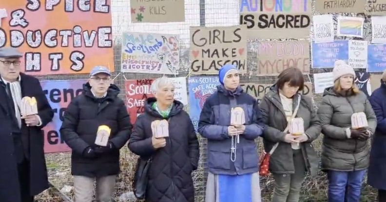 Members of an anti-abortion crowd protest outside of a hospital.