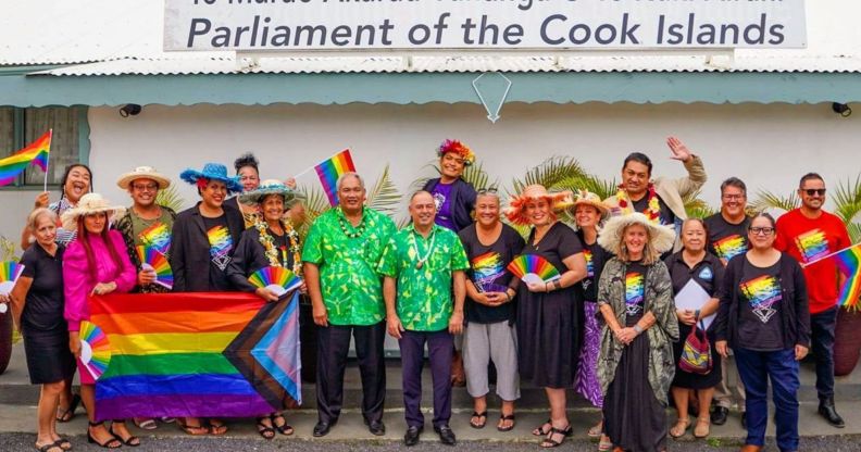 Members of Pride Cook Islands and parliament members celebrate outside Cook Islands parliament.