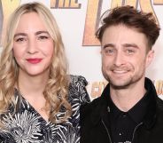 Erine Darke and Daniel Radcliffe pose for a red carpet photo.