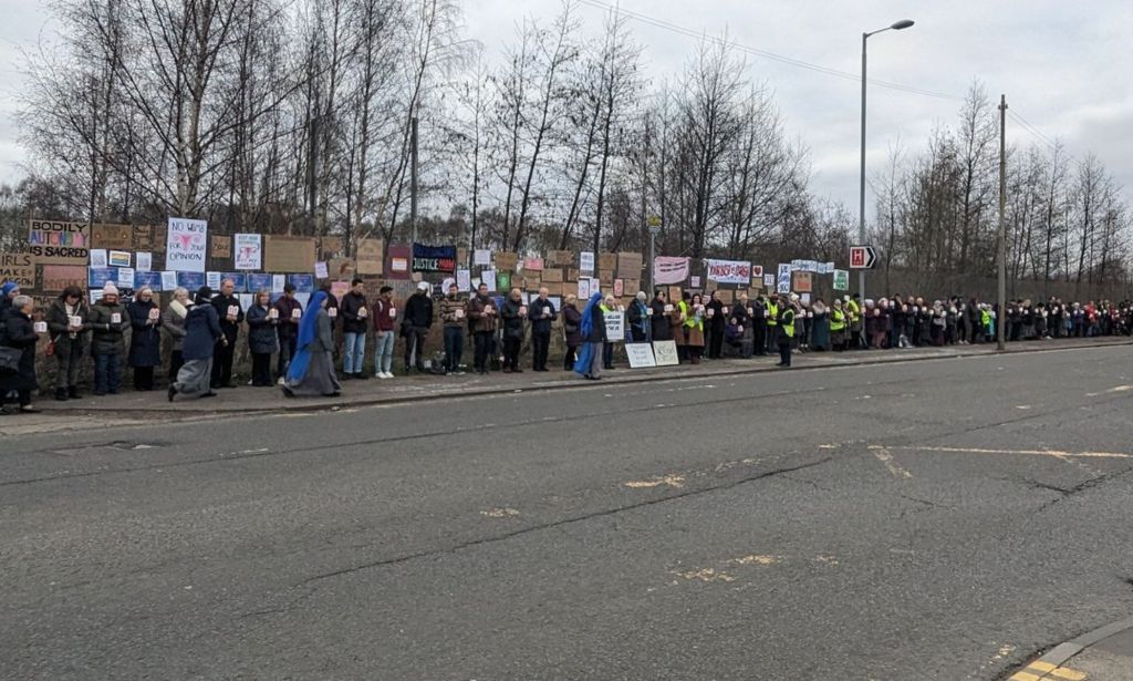 Anti-abortion protestors stand outside a local hospital.