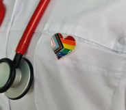 Silhouette of doctor in white coat with stethoscope and LGBT badge on pocket concept