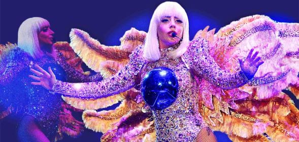 Lady Gaga, wearing a winged costume with a blue ball on her chest, performs onstage during The ARTPOP Ball tour opener