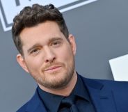 Michael Bublé in a blue suit and black shirt on the red carpet at the 2022 Billboard Music Awards.