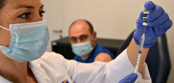 Nurse fills a syringe with the mpox vaccination