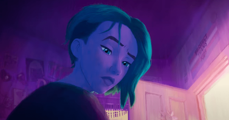 A still from the Spider-Man: Across the Spider-Verse trailer featuring Gwen Stacy with a Protect Trans Kids poster in the background