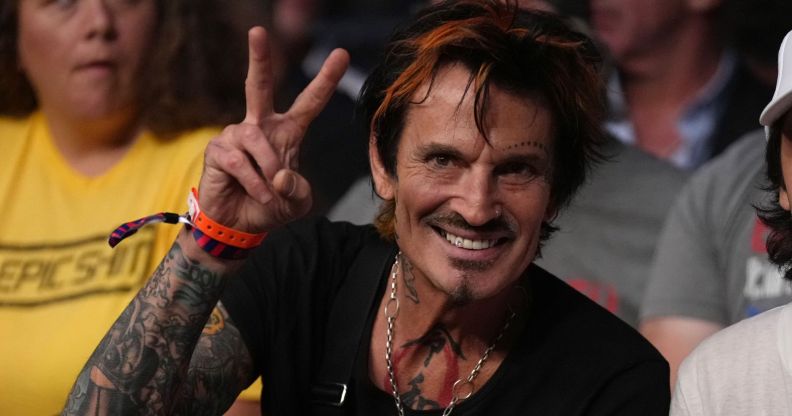 Tommy Lee giving a peace sign.