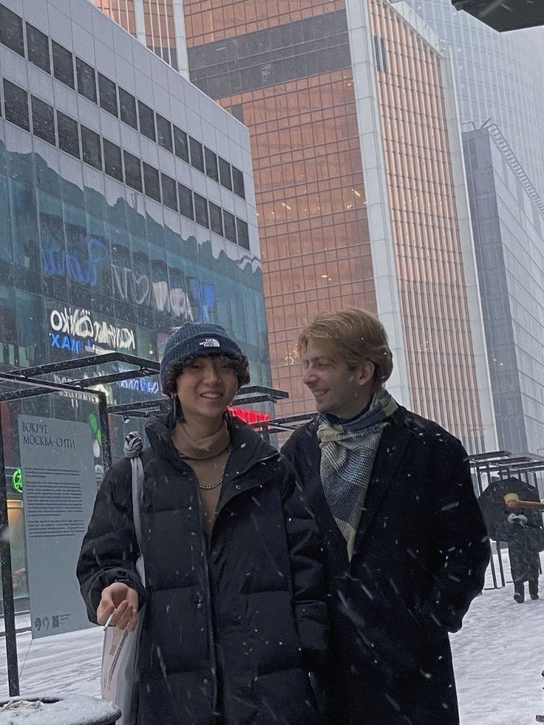 LGBTQ+ Russia based couple Gela Gogishvili and Haoyang Xu stand side-by-side as they walk together outside