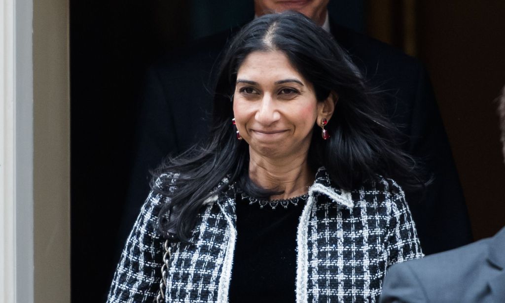 UK home secretary Suella Braverman wears a black and white patterned coat. LGBTQ+ and human rights campaigners have criticised Braverman for her comments about asylum seekers, including those from Sudan