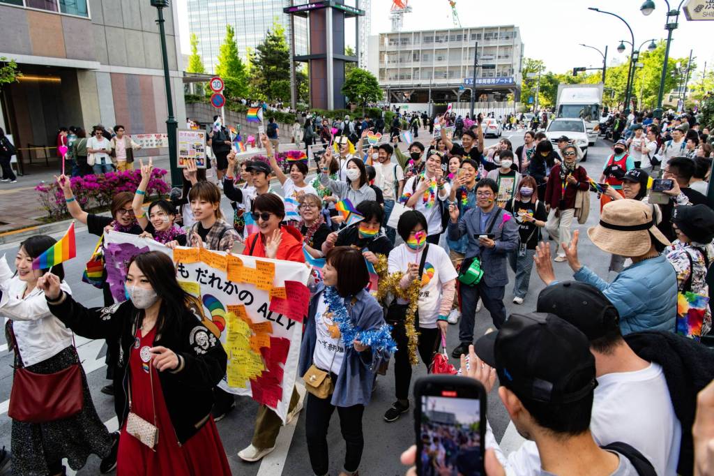 A group of people march down the streets of Tokyo, Japan during the LGBTQ+ Pride Parade, demanding further protections for queer people in the country