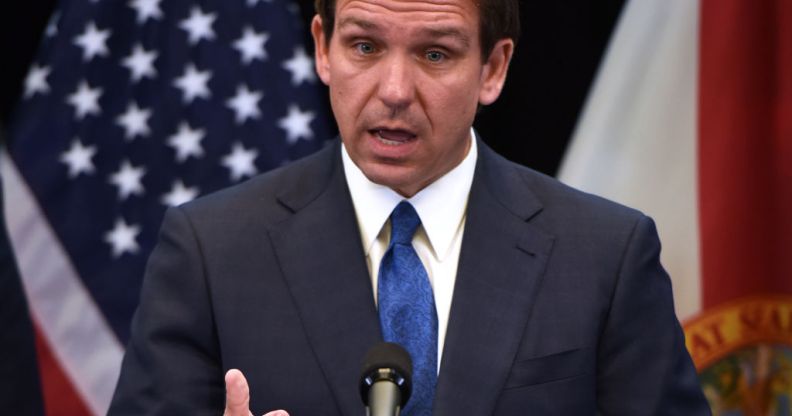 Ron DeSantis speaking in front of a US flag