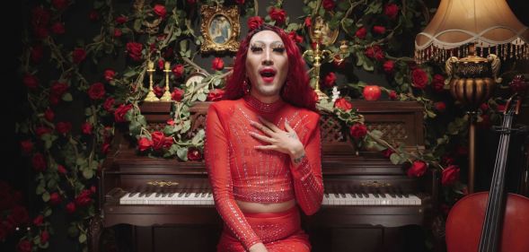 South Korean LGBTQ+ activist Heezy Yang is dressed, as his drag persona Hurricane Kimchi, in a red outfit as he sings