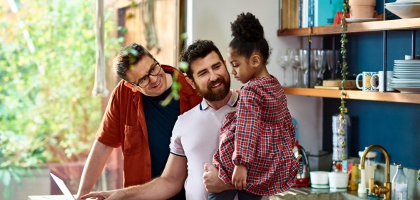 Family of two dads and one child, to illustrate a story about foster care