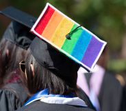 A picture of a person during graduation with a rainbow flag on their cap.