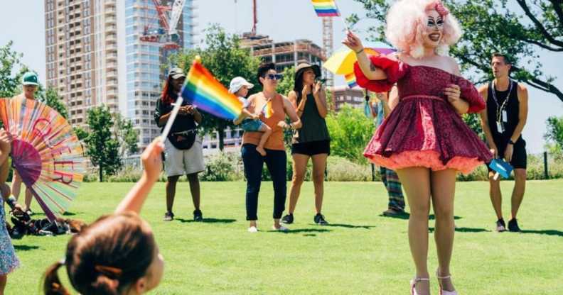 Texas drag queen Brigitte Bandit hosting a story time hour outdoors.