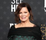 Close-up image of Marcia Gay Harden standing in front of a dark grey background