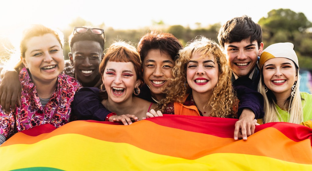 Diverse young friends celebrating gay pride festival - LGBTQ community concept