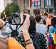 Woman taking a photograph of pride