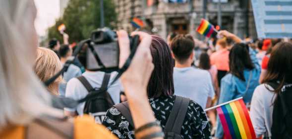 Woman taking a photograph of pride