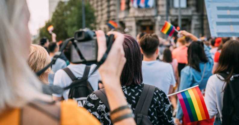 Woman taking a photograph of pride