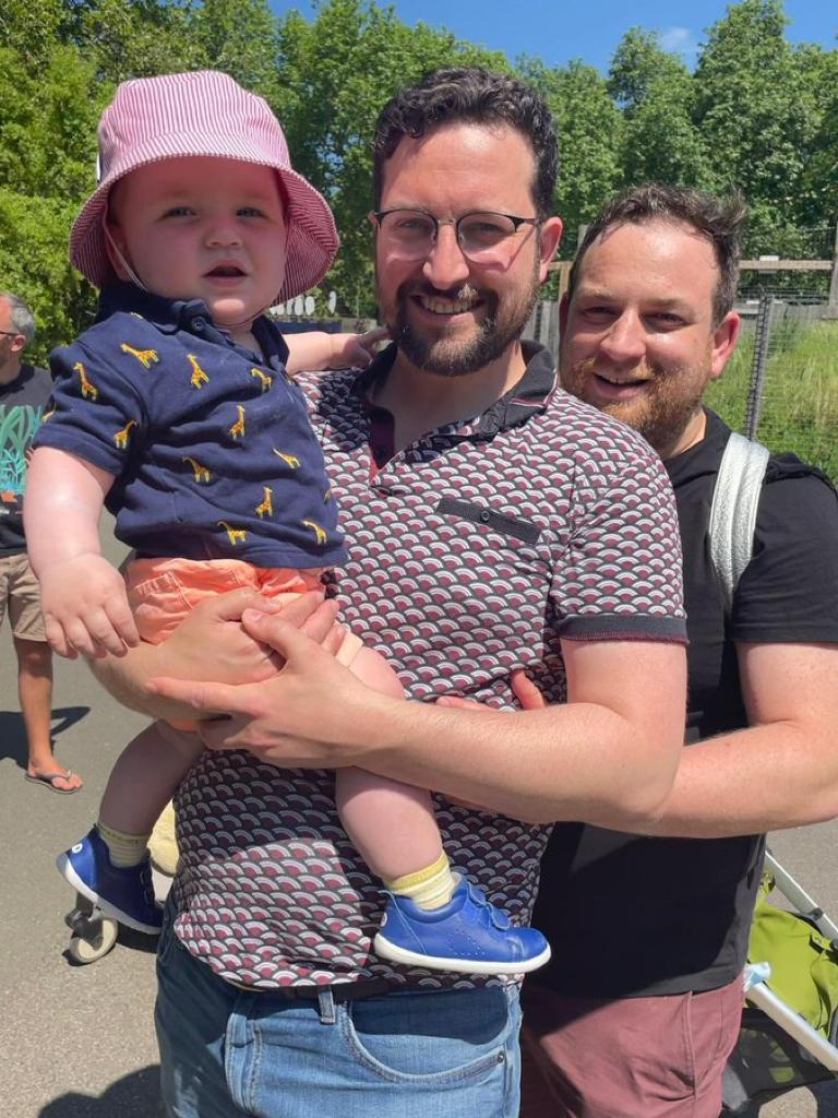 Paul Morgan-Bentley (C) with Robin Morgan-Bentley on the right. Paul is holding their son Solly.