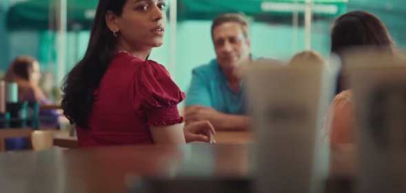 Screenshot from Starbucks ad showing Arpita looking at coffees