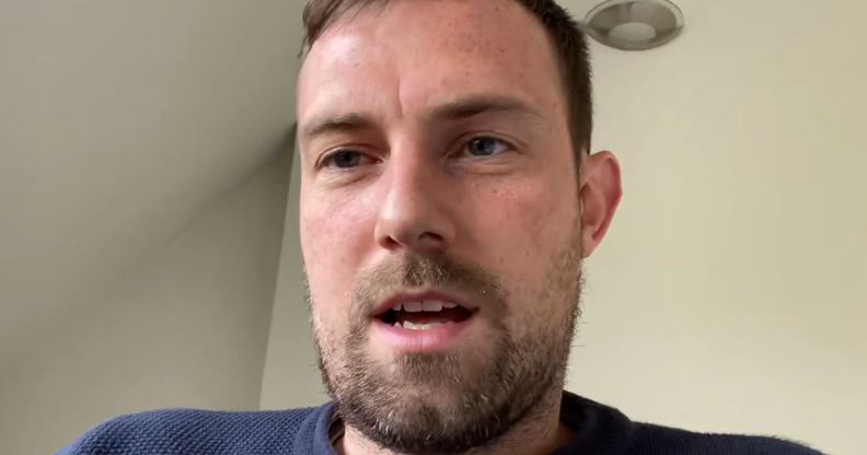 Joshua Sutcliffe, in a white room, speaking to a camera.