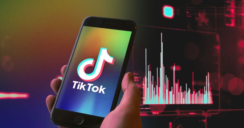 Hand holds phone with TikTok logo on the screen