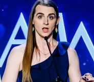 Zooey Zephyr, wearing a single-strap blue dress, speaking during the GLAAD Media Awards.