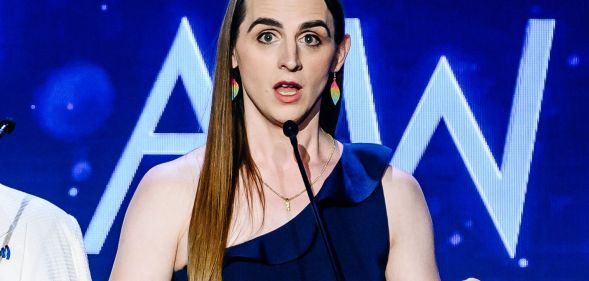 Zooey Zephyr, wearing a single-strap blue dress, speaking during the GLAAD Media Awards.