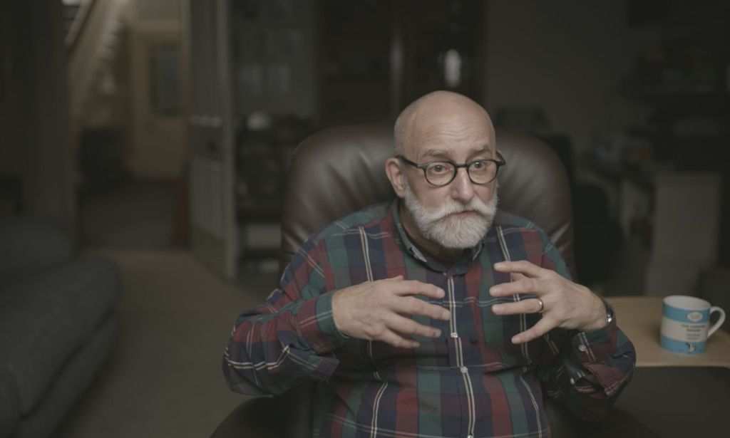 Doctor Stephen Whittle wears a plaid shirt as the trans activist is interviewed for Channel 4's documentary Gender Wars